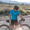 gravel cyclist getting ready to ride, wearing motion jersey in emerald